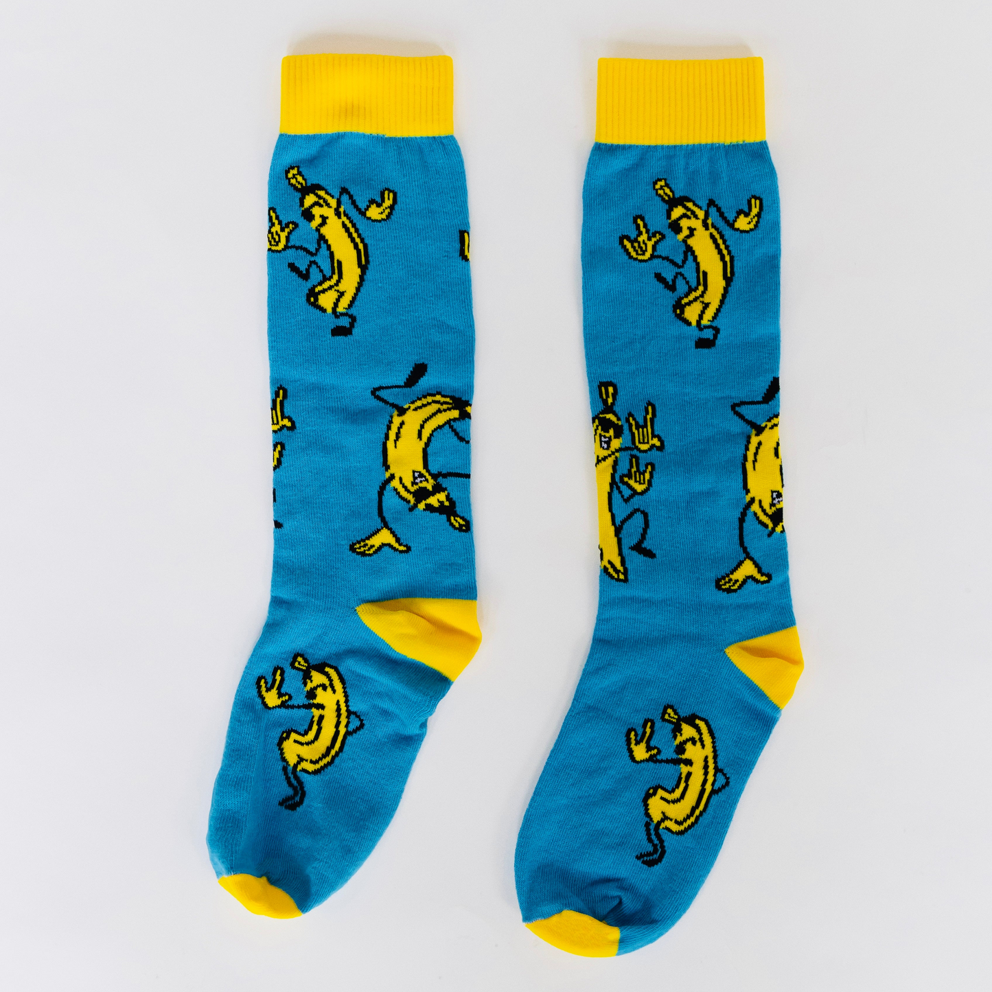 Blue socks with yellow accents and banana character pattern on a white background
